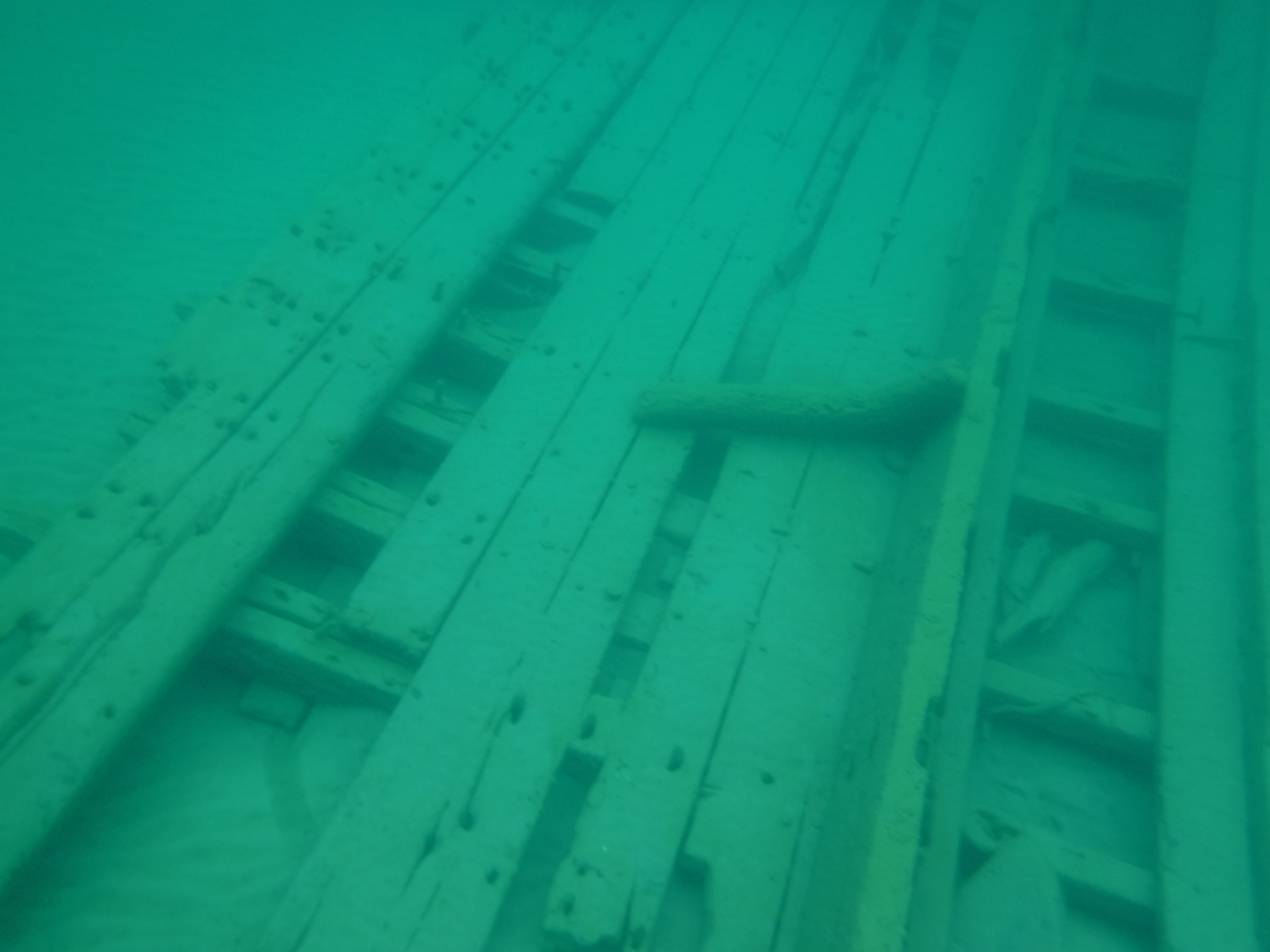A photo of a piece of the wooden hull of the wreck, Large Gas Boat.